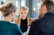 © BusinessClass by W61 - Happy businesswoman with colleagues sitting in office