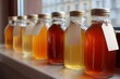 © BISO - Homemade kombucha in small bottles with empty labels by window