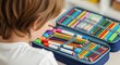 © Creative Concepts  - Over-the-Shoulder View of Child Looking into Full Pencil Case