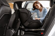 © Maria Vitkovska - Mother Installing Baby Car Seat in Vehicle