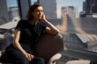 © BusinessClass by W61 - Thoughtful young businesswoman sitting on chair near window at office