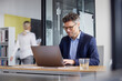 © BusinessClass by W61 - Businessman working on laptop in office