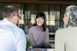 © BusinessClass by W61 - Smiling woman having a meeting with businessman and businesswoman in office