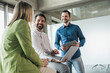 © BusinessClass by W61 - Smiling businessman with coworkers discussing at workplace