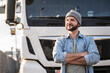 © BusinessClass by W61 - Smiling truck driver wearing knit hat standing in front of truck