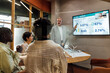© BusinessClass by W61 - Businessman explaining strategy to colleagues through video conference in board room