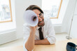 © BusinessClass by W61 - Smiling businessman looking through rolled up paper at office