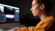 © Chandlerlikes - Woman editing photos on high-resolution monitor in modern editing suite