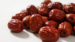 © cong - Red Plump Jujubes Stacked Wrinkles White Background