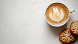 Cup of cappuccino with latte art and two cookies on white textured background, minimalistic breakfast or coffee break concept