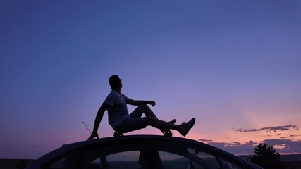 Wall Mural - man watching stars, milky way, planets, moon and other celestial objects from a car rooftop from a d