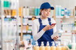 © JackF - Young woman worker in uniform scanning qr code for moisturizing cream in pharmacy