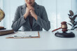 © Kritdanai - Legal professional in reflection: a legal professional contemplates next steps in the office, the gavel and world globe hinting at the scope of work