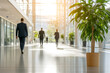 © A2Z AI  - Business professionals walk through a brightly lit, modern office space, creating a vibrant and productive atmosphere. Potted plants add a touch of nature.