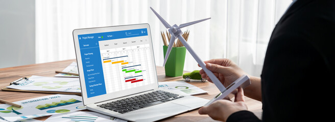 Poster - Project planning software for brisk business project management on the computer screen showing timeline chart of the team project