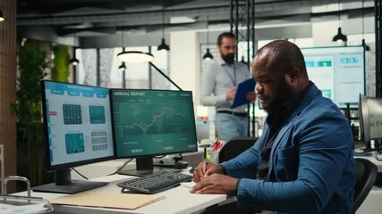 Poster - Black business consultant taking notes to create a new strategy and fulfill project goals in a modern office, writing some data insights to forecast a global expansion. Motivation for efficiency