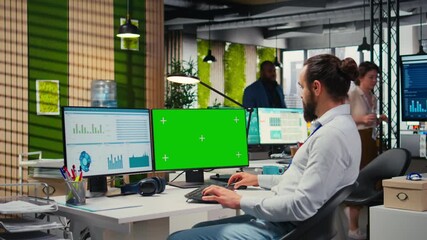 Poster - Employee engaged in business planning with a green screen in the office, does report writing to ensure alignment with objectives and optimize performance metrics. Corporate forecast. Camera A.