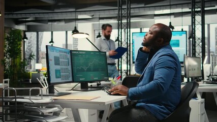 Poster - African american man with a stiff neck and backache stretching his muscles, correcting his bad posture while he works on business tasks. Focusing on organizational success. Camera A.