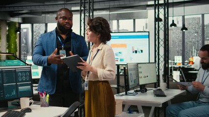 Poster - Two employees reviewing data insights on tablet in professional workspace, developing business solutions with strategy planning and performance metrics analysis for new goals achievement. Camera A.