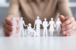 © Georgii - Hands holding paper cutout figures showcasing diversity and inclusion concepts