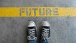 © Rifqi - Person wearing sneakers stands on a concrete floor marked with 'FUTURE' in yellow paint, concept for personal growth, career planning and making life decisions.