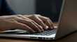 © HERNAWATIBINTI - Professional hands typing on a laptop keyboard, representing modern business communication and remote work.