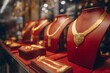 © Mia - A gold jewelry display with various necklaces, bracelets, and rings on mannequins in red pedestals. In the background is an elegant store decorated with golden decorations