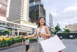 © dodotone - Walking asian woman travel and shopping in city lifestyles at outdoors on day