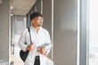 © Serhii - Medical student walking in university hallway carrying books