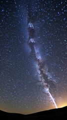 Wall Mural - a mesmerizing night sky video with a low-angle view capturing a star-filled sky and a streaking mete