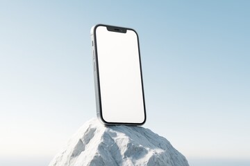 Poster - Smartphone with blank screen standing on rock under blue sky, ideal for tech display or mobile app mockup presentation in clean light style.