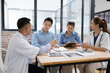 © SOMKID - Medical team having a meeting in conference room at hospital, Medical technology and health care concept.