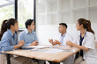 © SOMKID - Medical team having a meeting in conference room at hospital, Medical technology and health care concept.