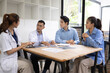 © SOMKID - Medical team having a meeting in conference room at hospital, Medical technology and health care concept.