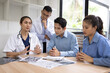© SOMKID - Medical team having a meeting in conference room at hospital, Medical technology and health care concept.