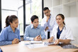 © SOMKID - Medical team having a meeting in conference room at hospital, Medical technology and health care concept.