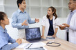 © SOMKID - Medical team with laptop computer and examine x ray test results for treatment plans in a modern hospital, Healthcare and medical concept.