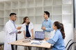 © SOMKID - Medical team with laptop computer and examine x ray test results for treatment plans in a modern hospital, Healthcare and medical concept.