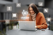 © fotofabrika - Woman smiling while interacting with a chat bot on her laptop in a cozy outdoor setting during a sunny afternoon