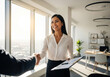 © Yhs City - Diverse Business Professionals Shaking Hands in Modern Office
