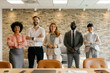 © Westend61 - Confident business team smiling in modern office portrait