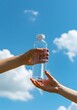 © purrfiction - Minimalist natural water bottle with hands holding, bright outdoor photography for healthy lifestyle promotion