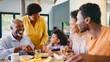 © Monkey Business - Family Shot With Grandparents Parents And Granddaughter At Breakfast Around Table At Home