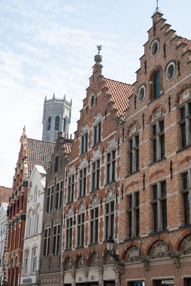 Medieval houses facades and rooftops and city tower with bells in the centre of Bruges, Flanders