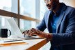 © (JLco) Julia Amaral - Man in glasses working on a laptop in an office environment