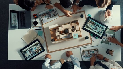 Poster - Top down view of manager pointing at house model and explain building design. Aerial view of architect engineer brainstorming about interior construction while tablet display house plan. Alimentation.