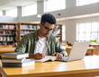 © Maryna Kurykhalova - A young student of mixed ethnicity sitting at a wooden table in a quiet, modern library, reading a hardcover book. Soft natural light coming from large windows. A calm, focused atmosphere.