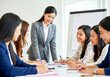 © Mdhittu - Empowered Meeting: A dynamic group of women collaborates around a conference table, sharing ideas and charting a course towards a future brimming with potential. The leader, radiating confidence.