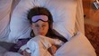 © kinomaster - Woman with sleep mask struggling to fall asleep at night in bed