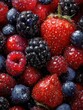 © Johannes - The vibrant assortment of fresh berries with droplets of water glistening.
